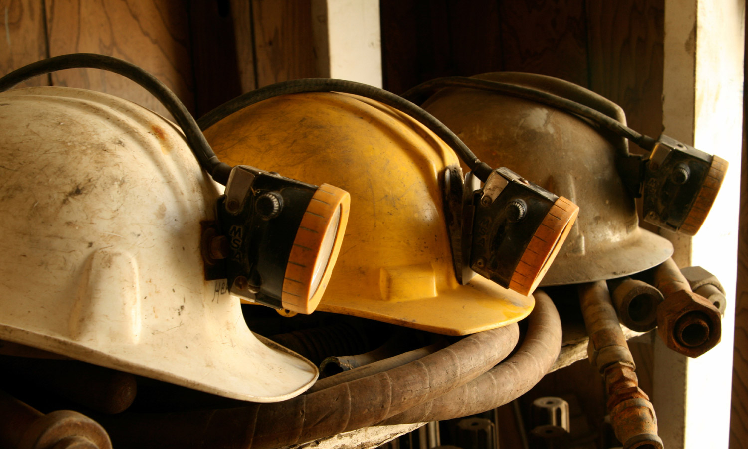 Close up on a row of mining helmets