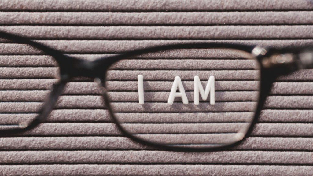Glasses with the word I am in the lens