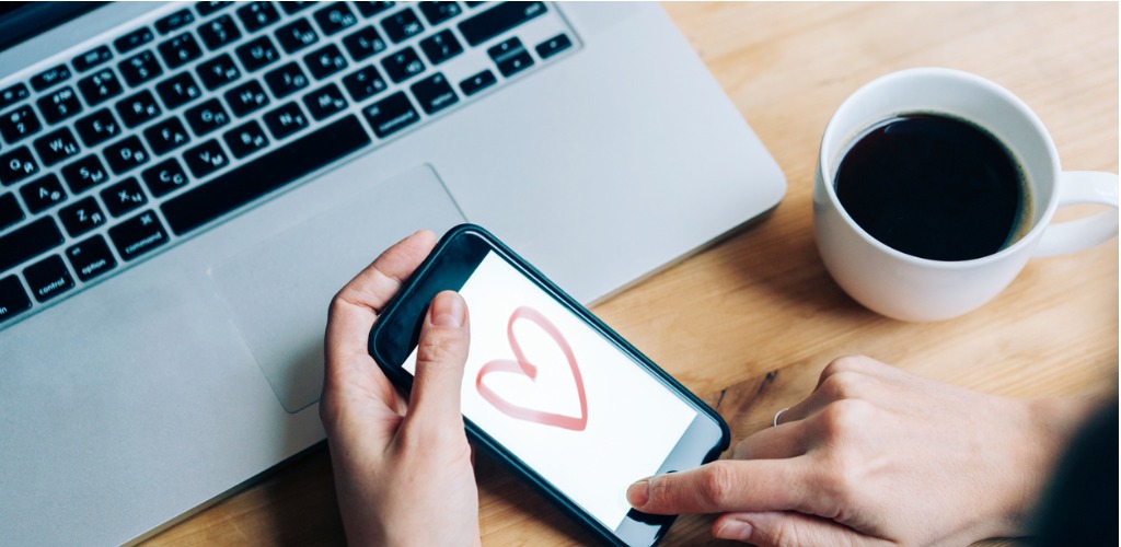 heart on phone screen on desk